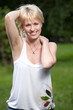 Young smiling cheerful blond woman 20-29 in the summer park