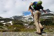 Young girl with backpack in the mountains Young girl with backpack in the mountains