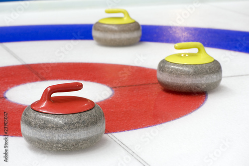 Photo: Group of curling rocks on ice Group of curling rocks on ice