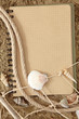Exercise book and seashell on sand Exercise book and seashell on sand