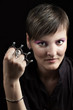 Young woman with knuckles against dark background