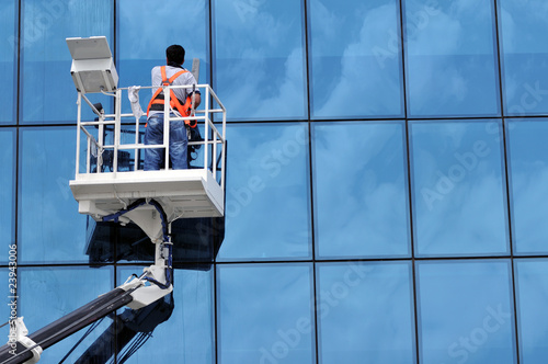 Photo: Window washing on high-rise office building in crane beam Window washing on high-rise office building in crane beam