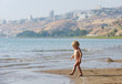 Child on the shore of lake Kinneret in the morning Child on the shore of lake Kinneret in the morning