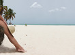 Girl sitting on the beach tree