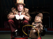 Circus clown with a monkey.