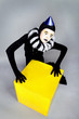 Ñircus fashion mime posing near a yellow square on a grey backgr