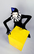 Ñircus fashion mime posing near a yellow square on a grey backgr