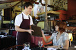 waiter giving menu to costumer at the restaurant