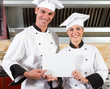 chefs holding white board in kitchen