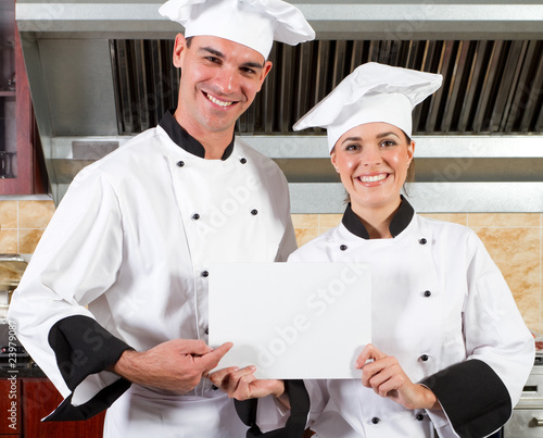 Photo: chefs holding white board in kitchen chefs holding white board in kitchen