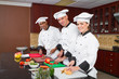 chefs cooking in industrial kitchen