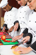 chefs cooking in industrial kitchen