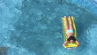 woman lying on inflatable mattress and oaring in water pool