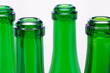 Green bottles necks close-up over white background