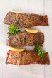 homemade hot smoked salmon fillet, on white wood with parsley a homemade hot smoked salmon fillet, on white wood with parsley a
