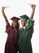 multi racial couple in cap, gown with diploma at graduation multi racial couple in cap, gown with diploma at graduation