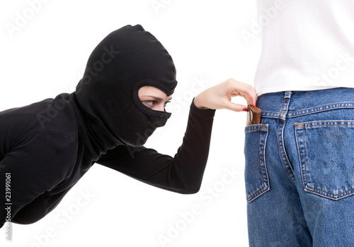 Photo: pickpocket in action - thief in balaclava pickpocket in action - thief in balaclava