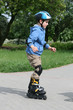Preschooler learning to ride on rollerblades