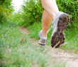 Running woman on trail in forest, motion blur Running woman on trail in forest, motion blur