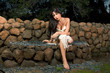 Sensual woman wrapped in scarf outdoors in garden