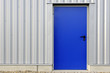 Cladding and blue door on a warehouse in Sarreguemines Cladding and blue door on a warehouse in Sarreguemines