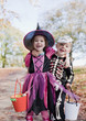 Laughing children in Halloween costumes