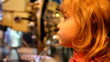 girl in space museum, listening  and watching the exhibit