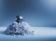 Metal globe on pile of shredded paper