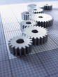 Close up of cogs on graph paper