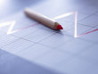 Close up of red pencil on graph