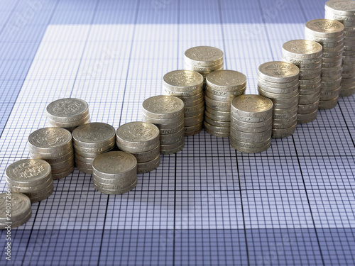 Photo: Stacks of pound coins forming ascending graph Stacks of pound coins forming ascending graph