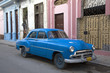 1950s Chevrolet sedan parked on dilapidated street