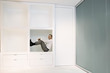 Businessman crouching in office shelf