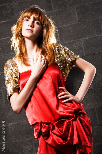 Fashionable red-haired woman in a satin red dress Fashionable red-haired woman in a satin red dress