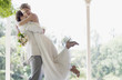 Groom hugging and lifting bride