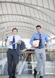 Businessmen waiting in train station