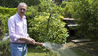 Photo: Handsome senior man working in a garden Handsome senior man working in a garden