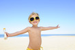 Photo : happy child with sunglasses and suntan lotion happy child with sunglasses and suntan lotion