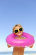 Photos : child with sunglasses and inflatable ring at the beach