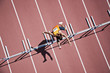 Runner jumping hurdles on track