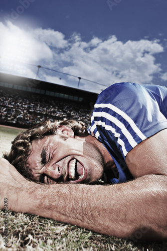 Photo: Frustrated soccer player laying on ground Frustrated soccer player laying on ground