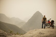 Man next to motorcycle viewing mountains