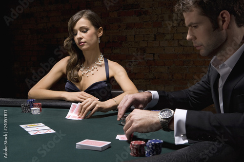 Photo: People playing poker in casino People playing poker in casino