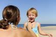 Photo : Mother applying sunscream to her happy child Mother applying sunscream to her happy child