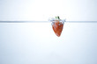 strawberry falling in the water