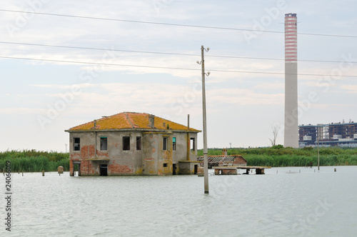 Photo: abandoned flooded farm and modern power plant abandoned flooded farm and modern power plant