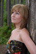 Beautiful young woman posing against tree Beautiful young woman posing against tree