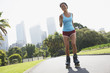 Woman rollerblading in urban park