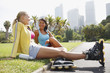 Friends resting in park after rollerblading
