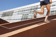 Photo: Man running up brick stair railing Man running up brick stair railing